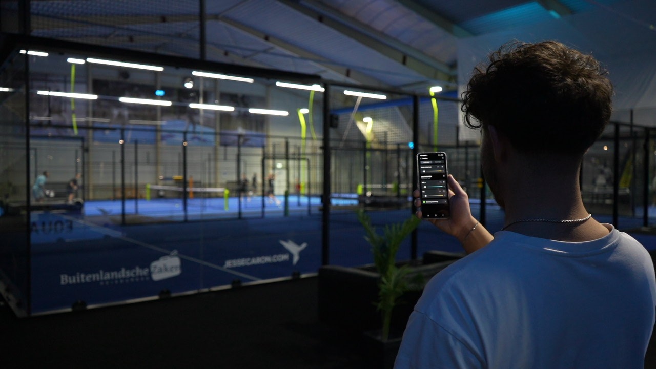 Someone controlling the systems next to the padel courts with a smartphone